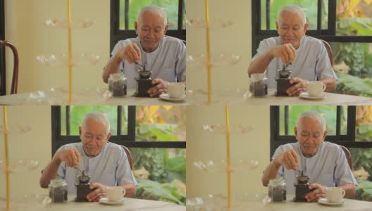 亚洲老人拿着老式咖啡机高清在线视频素材下载