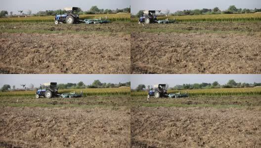 使用拖拉机在田里工作的农民高清在线视频素材下载