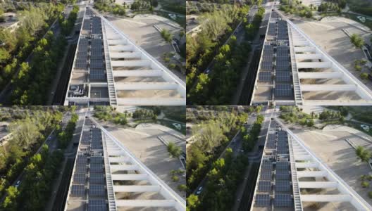 提供可再生能源的建筑物屋顶光伏板的鸟瞰图——无人机拍摄高清在线视频素材下载
