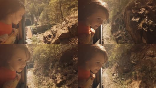 火车上的孩子——一个小女孩享受她的第一次火车旅行。山景窗外。高清在线视频素材下载