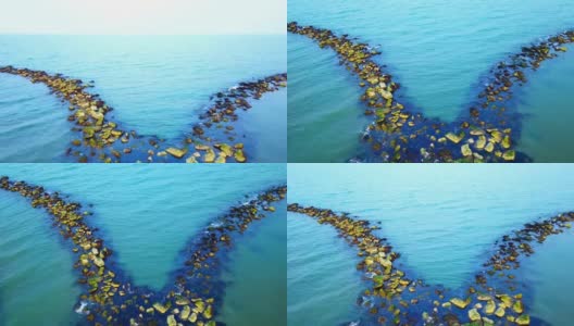 人造的防波堤在无边无际的蓝色大海中劈开高清在线视频素材下载