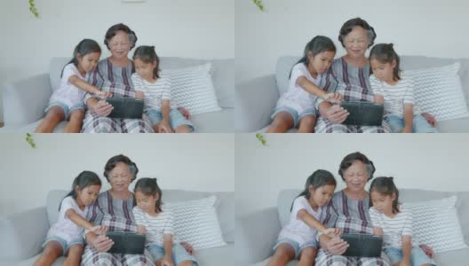 在客厅里，两个孙女一起帮奶奶用ipad。高清在线视频素材下载