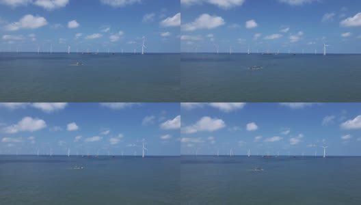 在一个阳光明媚的日子，远望海风发电厂高清在线视频素材下载