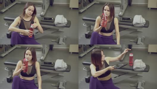 健身年轻女子在健身房训练后的休息期间喝瓶子里的水高清在线视频素材下载