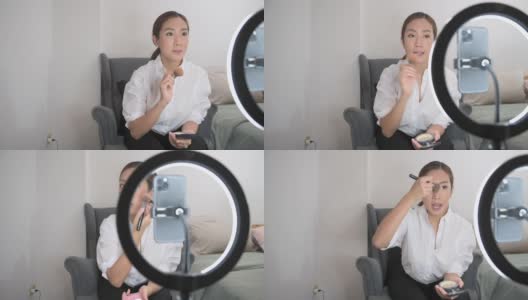 A beautiful Asian makeup blogger is live streaming how to beauty face makeup in her home高清在线视频素材下载