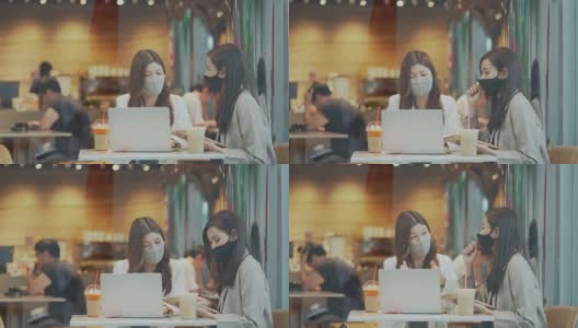 两个亚洲女性在商务会议上一起使用笔记本电脑进行讨论高清在线视频素材下载