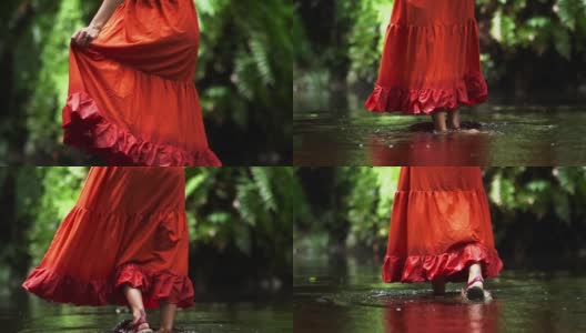 近距离观察女游客的腿与红色的服装在热带森林冒险。高清在线视频素材下载