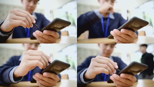 一名亚洲男子在智能手机上浏览照片高清在线视频素材下载