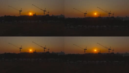 无人机拍摄日出在Sanamluang公园早上可以看到一个巨大的建筑起重机。高清在线视频素材下载