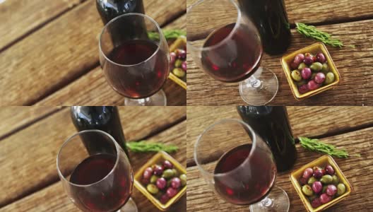 一杯红酒，橄榄和迷迭香放在木板上高清在线视频素材下载