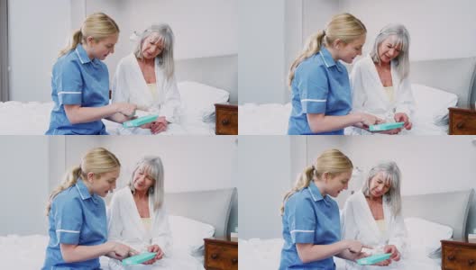 护士在家访中帮助老年妇女组织药物治疗高清在线视频素材下载
