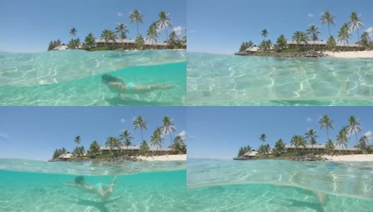 慢镜头:快乐的女人在遥远的热带岛屿附近玻璃般的海洋中潜水。高清在线视频素材下载