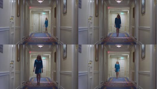 穿着蓝色裙子的漂亮女人走在豪华大厦的走廊上高清在线视频素材下载