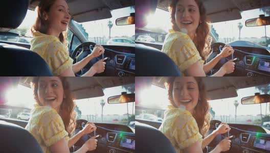 年轻女子开车微笑着坐在后座高清在线视频素材下载