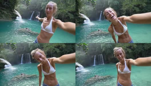 一名年轻女子在菲律宾宿务岛与美丽的瀑布自拍。人们旅游自然自拍的概念。一个人只喜欢户外和一个宁静的环境-慢动作视频高清在线视频素材下载