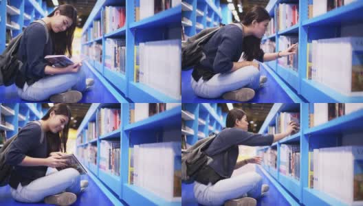 亚洲美丽的大学生在图书馆工作高清在线视频素材下载