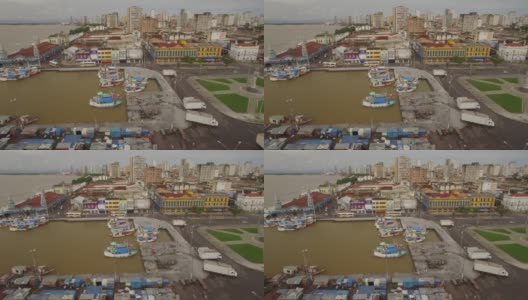 在巴西亚马逊的旧港口城市贝伦杜帕拉(Belem do Para)，码头上的船只和殖民时期的建筑物侧面架空高清在线视频素材下载