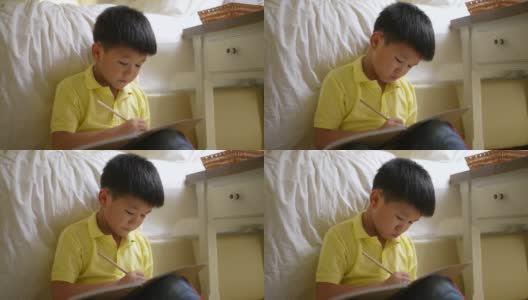 亚洲孩子用耳机在线学习。新常态研究与检疫的概念高清在线视频素材下载