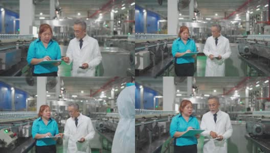 亚洲中国工厂检验员和领班在生产线上与生产线工人的工作背景讨论矿泉水质量和生产进度高清在线视频素材下载