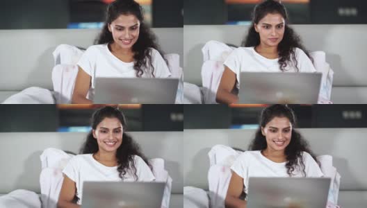 印度女子在床上使用笔记本电脑高清在线视频素材下载