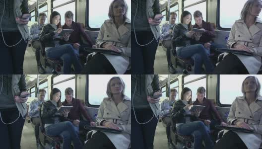 在公交车上玩平板电脑的通勤者高清在线视频素材下载
