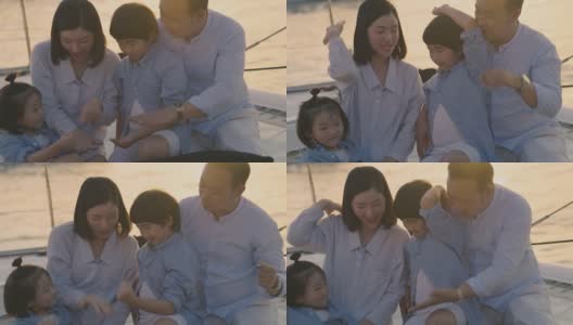 带着两个孩子的亚洲家庭乘船游玩。高清在线视频素材下载
