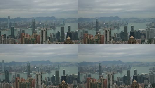 4k，俯瞰香港城市景观，俯瞰太平山顶，展现繁忙的维多利亚港和中国香港中环金融区，香港岛的天际线和一对鹰在城市上空飞翔。高清在线视频素材下载