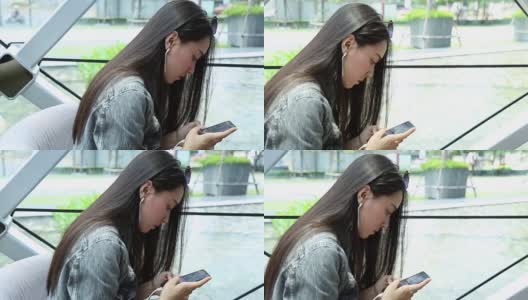 欧亚，年轻的亚洲女性在智能手机上打字的镜头高清在线视频素材下载