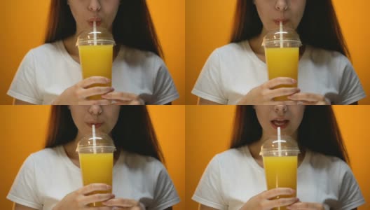 女孩喝橙汁，坚持健康饮食和维生素平衡，特写高清在线视频素材下载