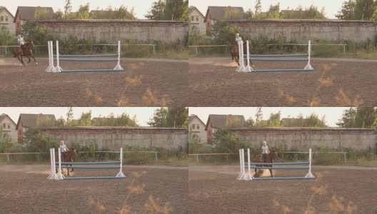 骑着一匹棕色马的女孩跳过了栅栏。高清在线视频素材下载