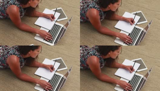 女性高管一边用笔记本电脑写4k日志高清在线视频素材下载