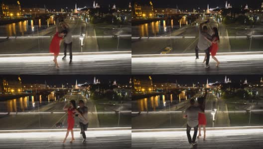 在莫斯科市中心的一座桥上，一男一女正在跳舞。高清在线视频素材下载