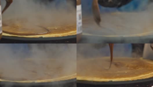 慢镜头小贩在巴黎街头的金属煎锅上做薄饼高清在线视频素材下载