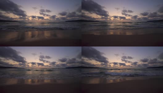 热带海滩和美丽的大海日出。戏剧性的云和舞动的海浪高清在线视频素材下载