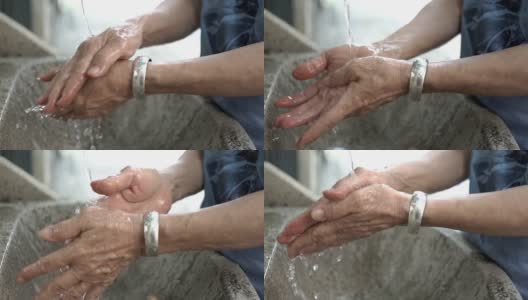 SLO MO老年妇女洗手是为了清洁双手，防止细菌和病毒，健康的理念高清在线视频素材下载