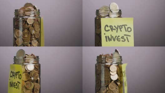 装有硬币和两枚欧元硬币的旋转玻璃罐，上面有加密货币投资文字，灰色背景高清在线视频素材下载