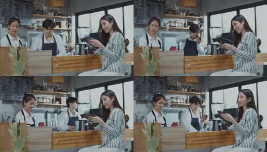 一个美丽的亚洲女人在咖啡馆用智能手机写信息。高清在线视频素材下载