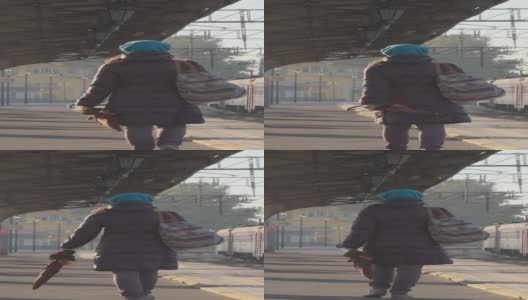 秋天，一个女人走在火车站台上高清在线视频素材下载