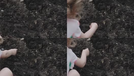 小女孩种下了花的种子。覆盖着地球。近距离高清在线视频素材下载