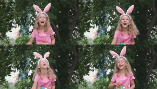 快乐的小女孩把复活节彩蛋放进篮子里高清在线视频素材下载