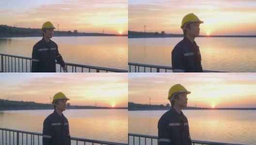 日落时分戴着防护头盔的男性工程师。高清在线视频素材下载