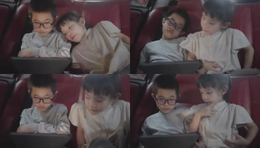 亚洲的兄弟姐妹在车里用数码平板电脑看视频或电影时放松，亚洲的家庭生活方式带有科技设备的概念高清在线视频素材下载