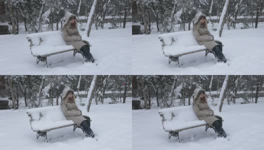 坐在暴风雪下的女人高清在线视频素材下载