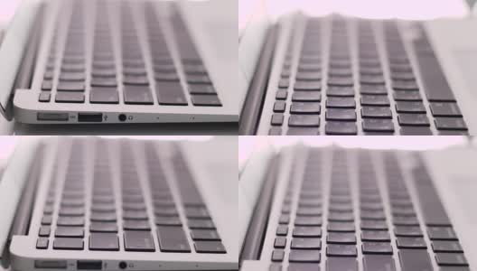 近景摄影:笔记本电脑键盘上的现代书桌高清在线视频素材下载