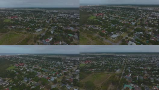 在城市郊区的家庭住宅上空飞行。民用卫星航拍全景图。南非伊丽莎白港高清在线视频素材下载
