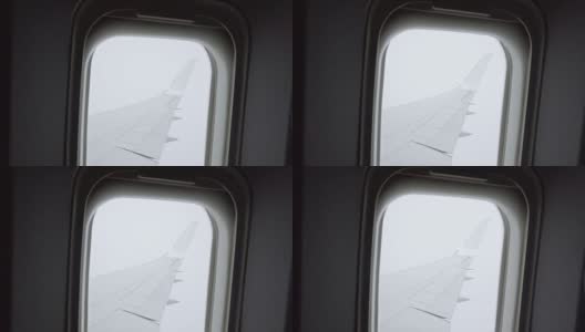 遇到气流时从飞机窗口观看高清在线视频素材下载