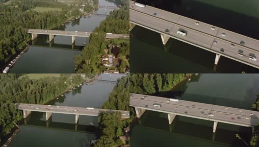 阳光下，汽车在河上的桥上行驶高清在线视频素材下载
