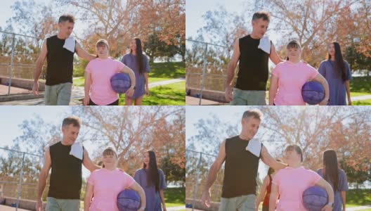 患有唐氏综合症的女孩和家人一起打篮球高清在线视频素材下载