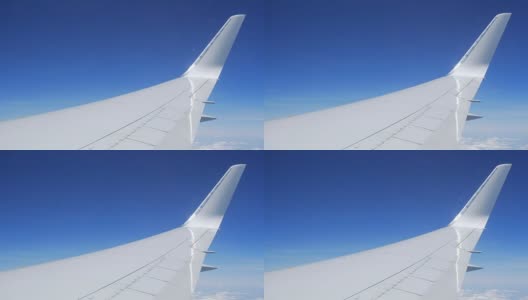在飞行过程中从窗口观看飞机机翼高清在线视频素材下载