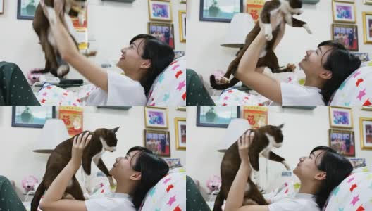 亚洲女孩在家里抱着她的猫高清在线视频素材下载